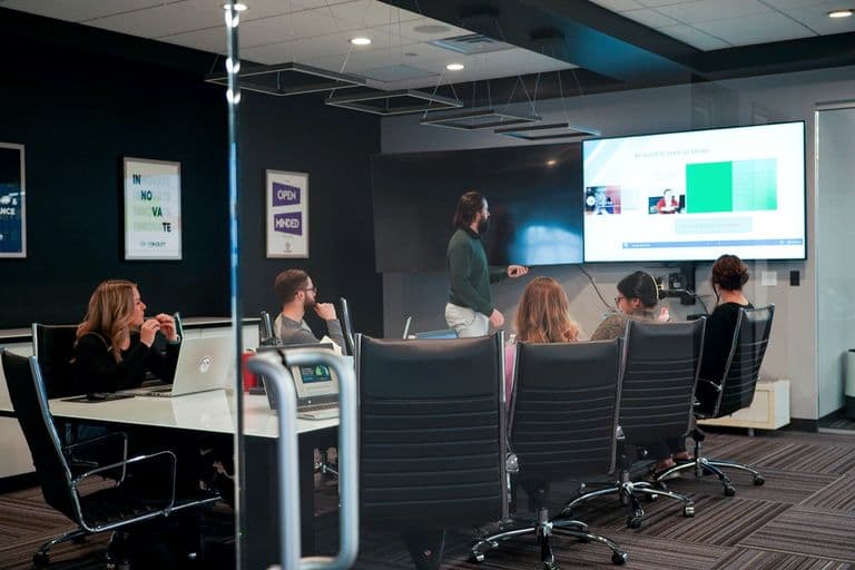 A Conduit team meeting in a glass conference room