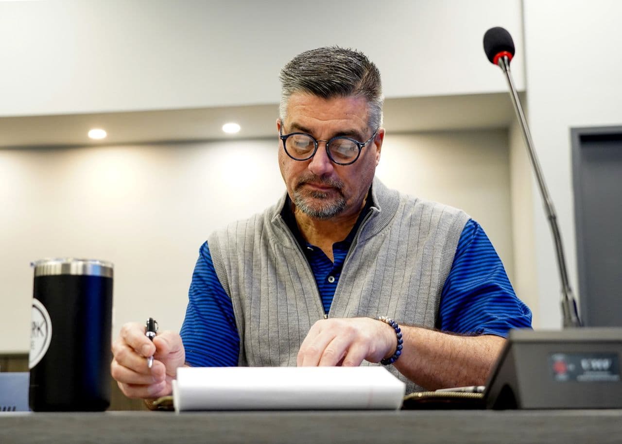 A Conduit strategist reviewing a plan at his desk