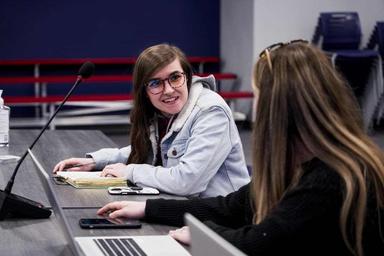 Two Conduit team members in conversation