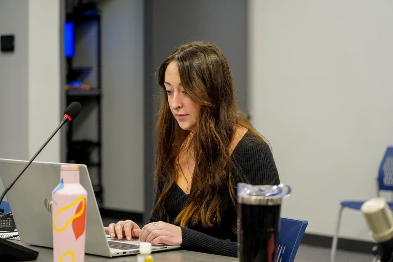 A Conduit analyst working at her laptop