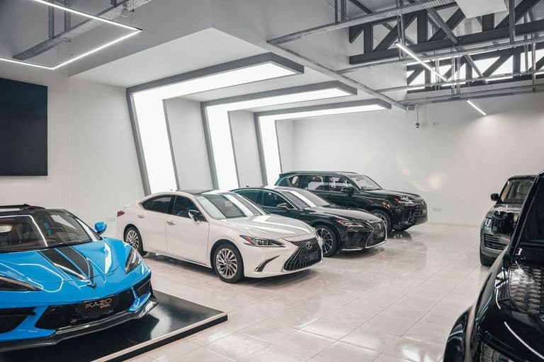 A modern auto dealership showroom lined with vehicles
