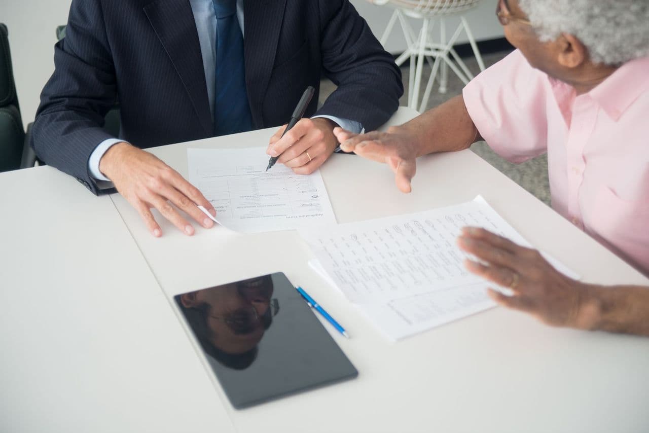 A financial advisor walking a client through documents