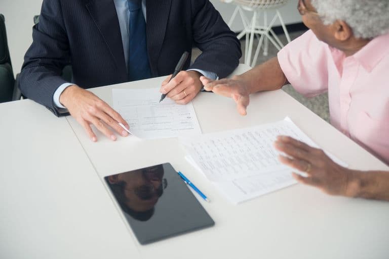 A financial advisor walking a client through documents
