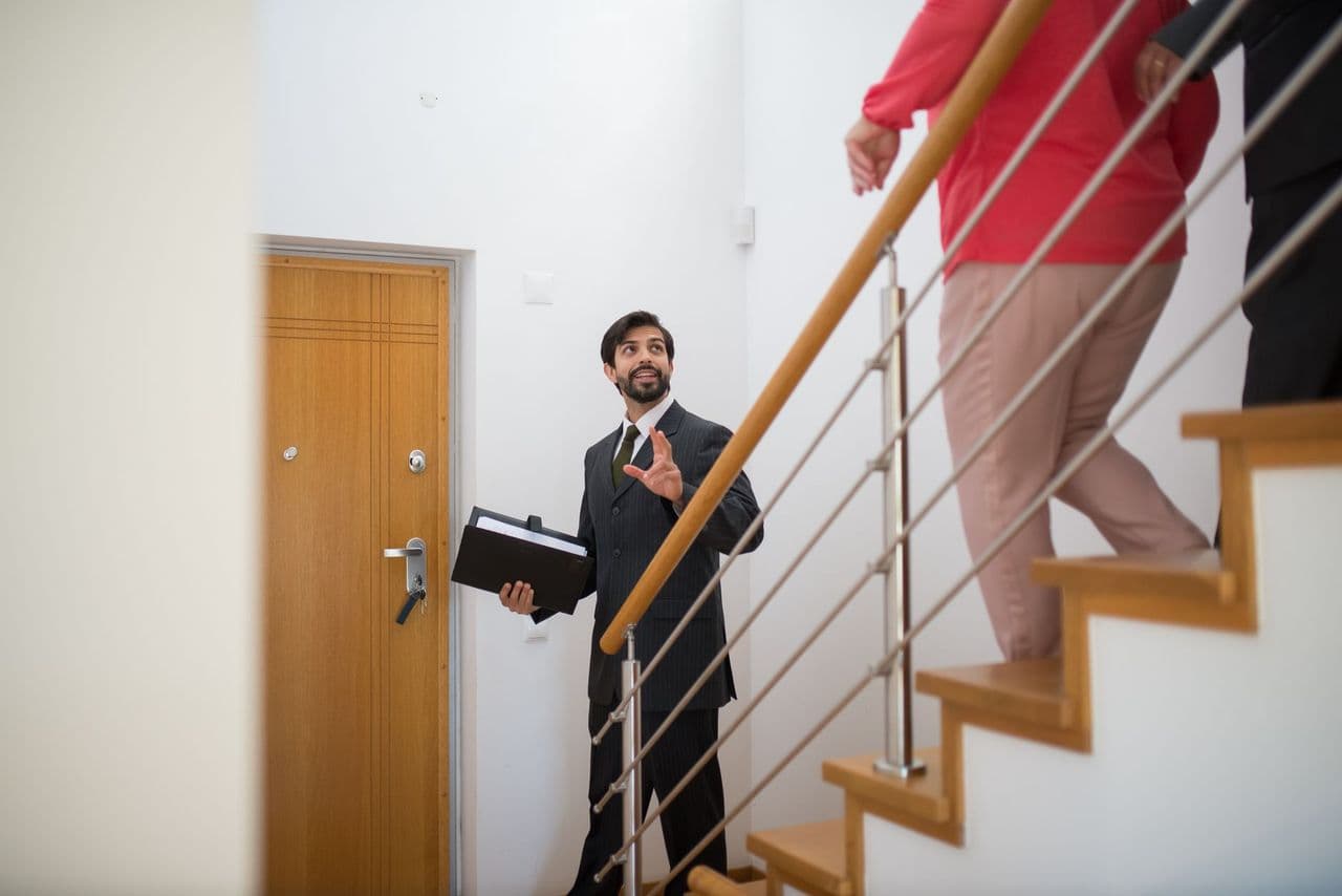 A real estate agent giving buyers a home tour