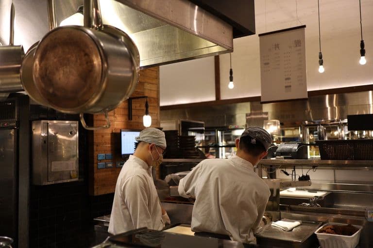 Chefs working the line in a professional restaurant kitchen