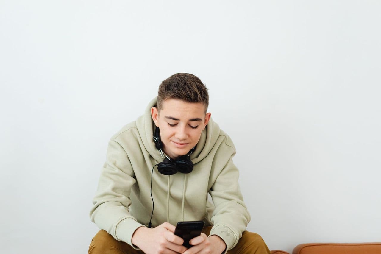 Young person enjoying technology, wearing casual clothes and headphones