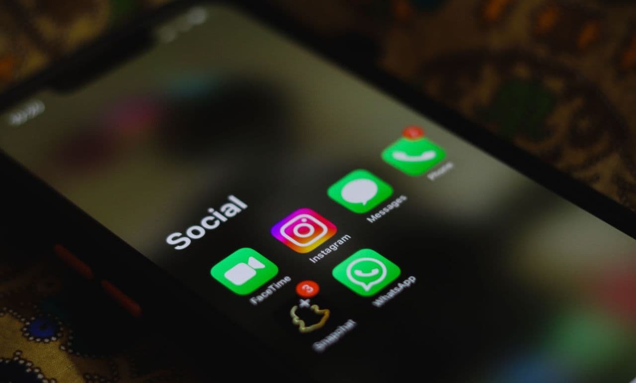 A close-up shot of smartphone displaying social media apps icons on screen