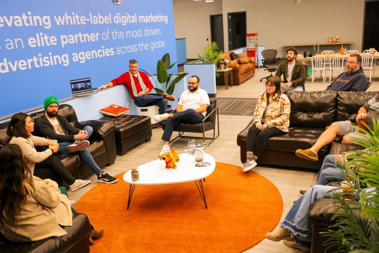 The Conduit team gathered in the office lounge